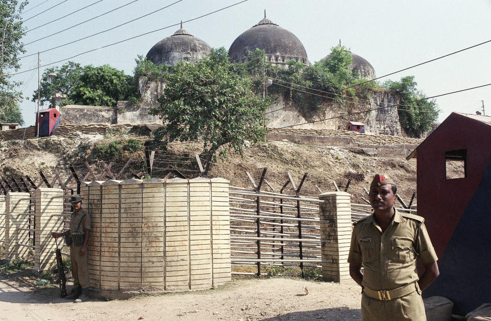 FILE - Security officers guard the Babri Mosque in Ayodhya, closing off the disputed site claimed by Muslims and Hindus, Oct. 29, 1990. Hindus believe that Hindu deity Ram was born at the exact same site in Ayodhya where the 16th-century Babri mosque once stood. The mosque was destroyed by a Hindu mob in December 1992. (AP Photo/Barbara Walton, File)