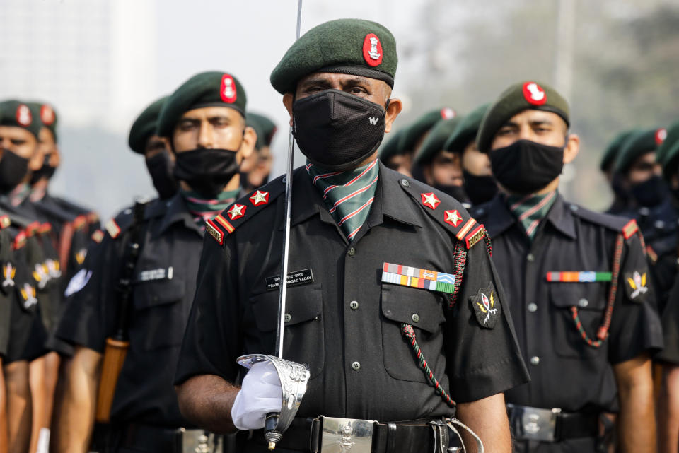 Indian army soldiers wearing face mask to prevent the spread of the coronavirus march during rehearsals of Republic Day parade in Kolkata, India, Friday, Jan. 22, 2021. (AP Photo/Bikas Das)