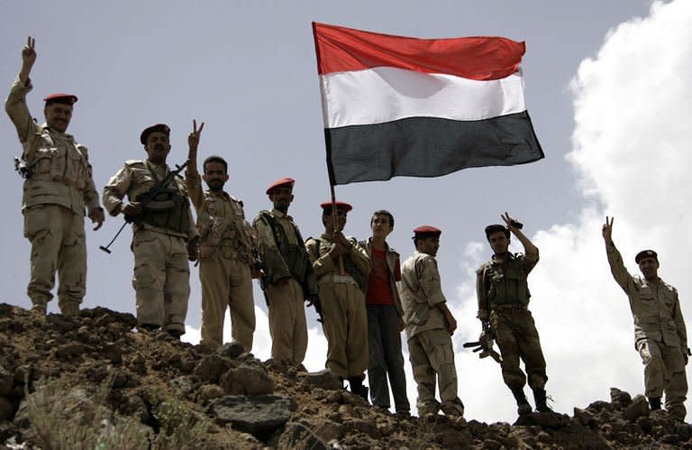 Yemeni army soldiers who defected to the opposition wave their national flag in Sanaa. A Gulf mediator flew out on Sunday after failing to secure Yemeni President Ali Abdullah Saleh's signature on a transition deal for him to quit office, although his ruling party signed the accord