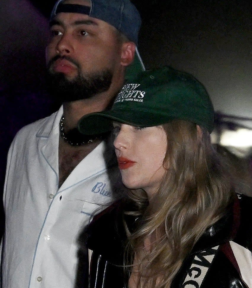 Taylor in a ballcap with the "New Heights" logo