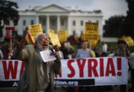 Protester Ashraf El-Bayoumi shouts against a military strike against Syria during the "Act now to stop war and end racism" (ANSWER) coalition rally outside the White House in Washington, August 29, 2013. The group rallied their opposition to a U.S.-led military action on Syria. REUTERS/Jason Reed (UNITED STATES - Tags: POLITICS CIVIL UNREST)