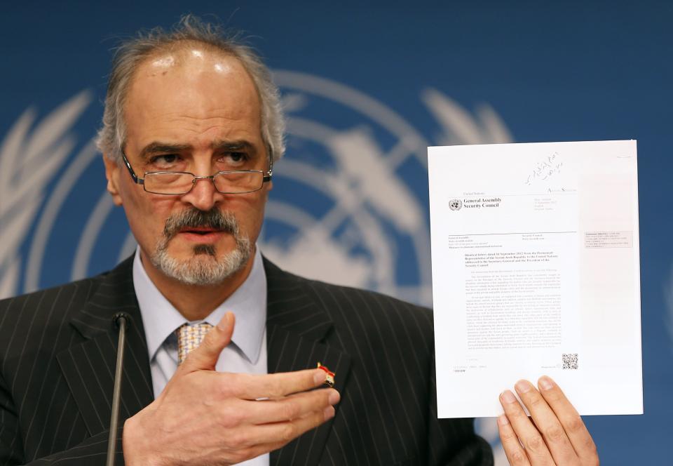 Syria's envoy to the United Nations Bashar Jaafari speaks and shows a document during a news conference after the Geneva-2 peace talks in Montreux