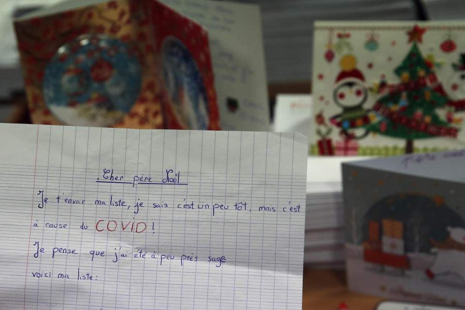 An letter addressed to "Pere Noel" - Father Christmas in French - that reads : "I send you my list, it is a bit early but it is because of COVID. I think I have been a little wise, so here is my list, in Libourne, southwest France, Monday, Nov. 23, 2020. Letters pouring by the tens of thousands into Santa's mailbox offer a glimpse into the worries and hopes of children awaiting a pandemic-hit Christmas. Along with usual pleas for toys and gadgets, kids are also mailing requests for vaccines, for visits from grandparents, for life to return to the way it was. The office estimates that one letter in three mentions the pandemic. (AP Photo/Francois Mori)