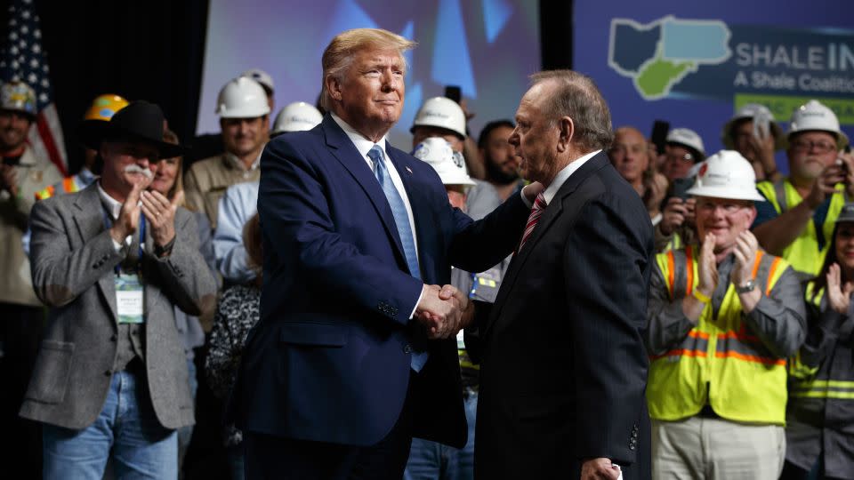 President Donald Trump shakes hands with Continental Resources CEO Harold Hamm at an event in Pittsburgh in 2019. - Evan Vucci/AP