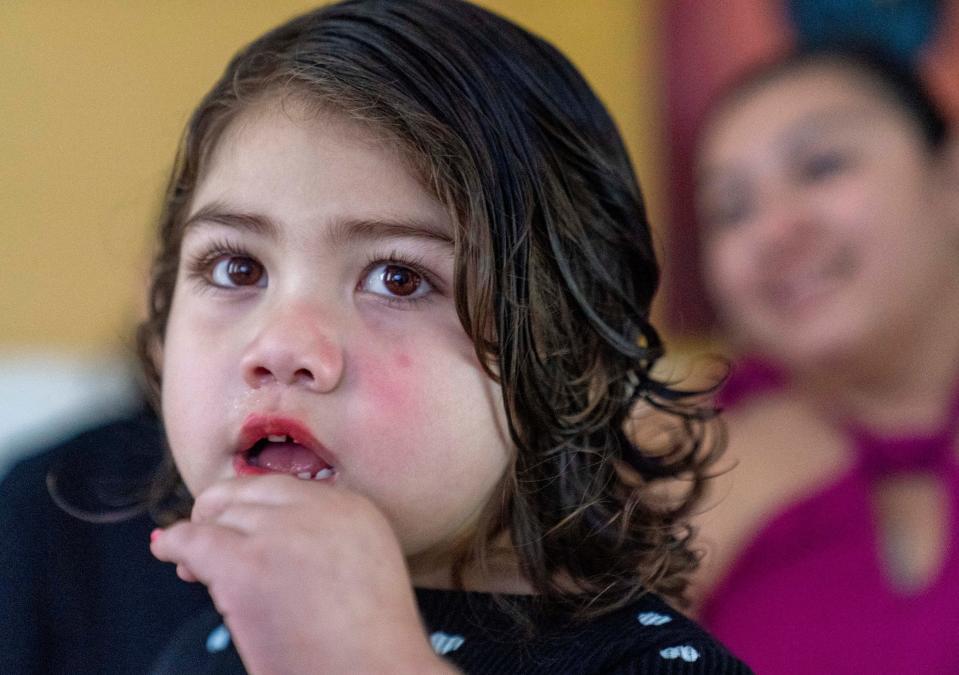 Amy Galeano, 4, puts on lipstick at her home in Lake Worth Beach. The only other children she can interact with regularly is her 9-year-old sister.