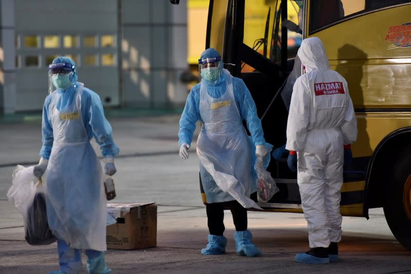 Malaysia?s health officials in protective suits prepares for the arrival of evacuated Malaysian nationals at Kuala Lumpur International Airport in Sepang