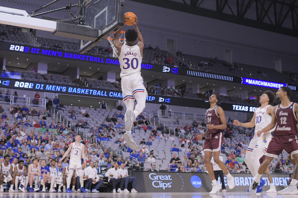 FORT WORTH, TX - MARCH 17: Ochai Agbaji #30 of the Kansas Jayhawks dunks an alley-oop against the Texas Southern Tigers during the second half during the first round of the 2022 NCAA Men's Basketball Tournament held at Dickies Arena on March 17, 2022 in Fort Worth, Texas. (Photo by Andy Hancock/NCAA Photos via Getty Images)