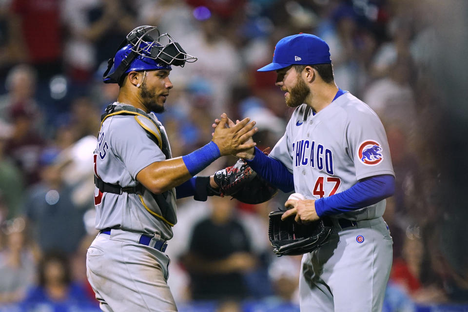 Chicago Cubs' Brandon Hughes, right, celebrates with Willson Contreras after the team's win over the Philadelphia Phillies in 10 innings in a baseball game Saturday, July 23, 2022, in Philadelphia. The Cubs won 6-2. (AP Photo/Matt Rourke)