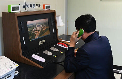 outh Korean government official checks the direct communications hotline to talk with the North Korean side at the border village of Panmunjom - Credit: South Korean Unification Ministry via Getty Images