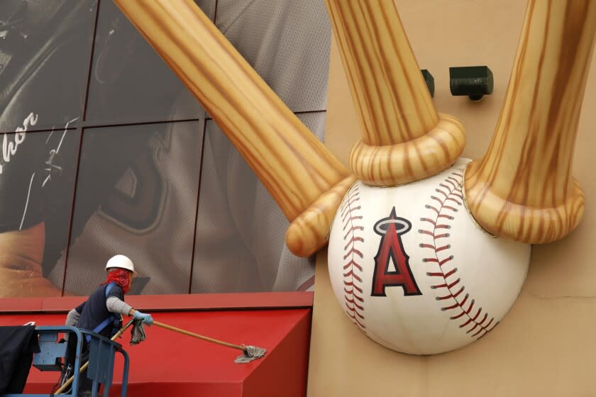 ANAHEIM, CA - MAY 23, 2022 - - A worker washes an awning in front of Angel Stadium in Anaheim on May 23, 2022. Facing community pressure to delay or cancel the Angel Stadium sale amid a corruption investigation into Anaheim Mayor Harry Sidhu, the Angels on Friday gave the Anaheim City Council 25 days to grant final approval to the deal. (Genaro Molina / Los Angeles Times)