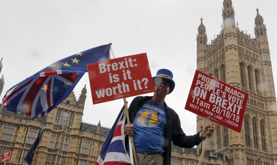 A demonstrator protests in front of parliament in London, Wednesday, Oct. 17, 2018. Britain's Prime Minister Theresa May will head to Brussels later Wednesday to meet with European Union leaders for what is widely billed as a "moment of truth" Brexit summit. (AP Photo/Frank Augstein)