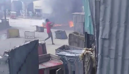 A man throws an object on a street in Mogadishu, Somalia April 13, 2019 in this still image taken from a video obtained on social media. Wadani Xasan Cade via REUTERS