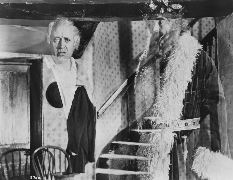 A transparent Ebenezer Scrooge (Alastair Sim) and the Spirit of Christmas Present (Francis De Wolff) watch what may become in A Christmas Carol. (Photo by &#x00fffd;&#x00fffd; John Springer Collection/CORBIS/Corbis via Getty Images)