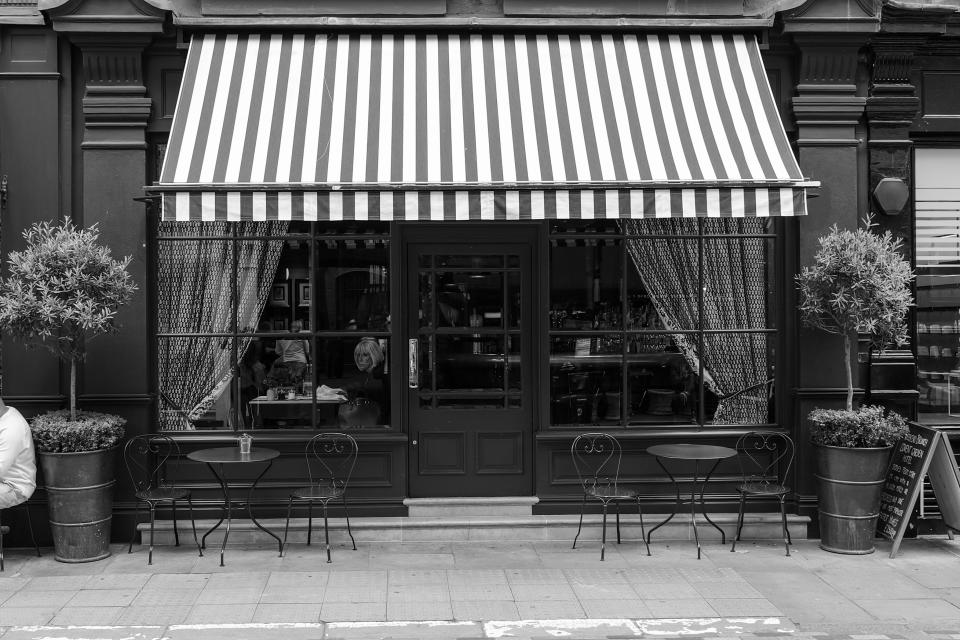 The outside of a restaurant with its awnings pulled down