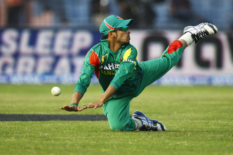 Bangladesh’s Nasir Hossain dives to catch the ball while fielding during the Asia Cup one-day international cricket tournament against Afghanistan in Fatullah, near Dhaka, Bangladesh, Saturday, March. 1, 2014. (AP Photo/A.M. Ahad)