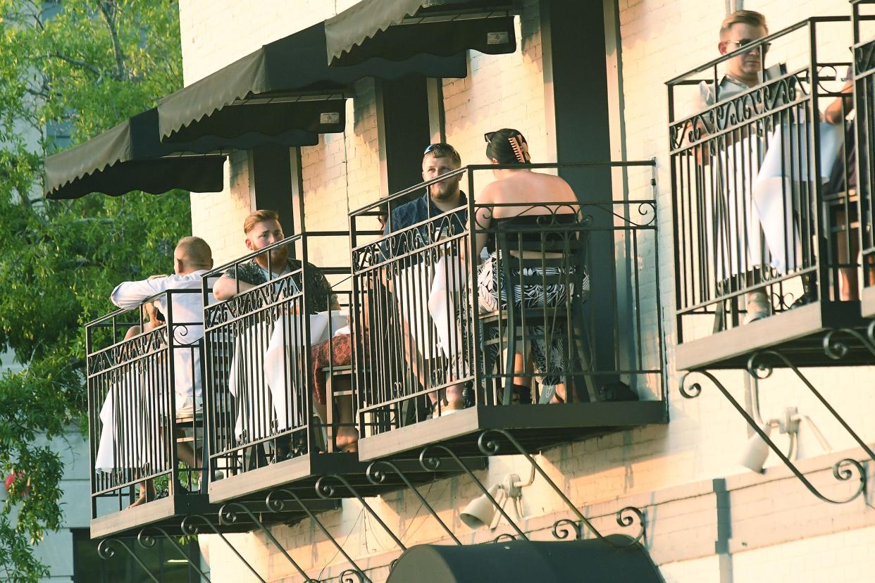 People enjoy the Riverwalk in downtown Wilmington while eating outside at Floriana Wilmington. STARNEWS FILE PHOTO