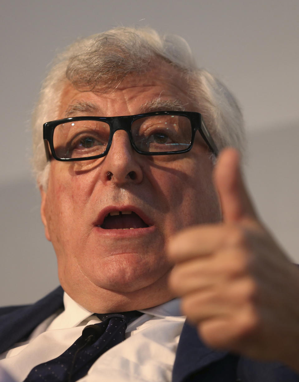 In this photo taken on June 13 2013, Prada fashion group CEO Patrizio Bertelli gestures as he attends a conference on fashion in Milan. Concern that Milan is losing prestige to London, Paris and New York is cracking the well-appointed composure of Milan's fashion world. The Italian National Fashion Chamber has been moved to action, announcing a reorganization this spring and making Prada's outspoken CEO Patrizio Bertelli the No. 2, with the goal of revitalizing Milan fashion. (AP Photo/Luca Bruno)