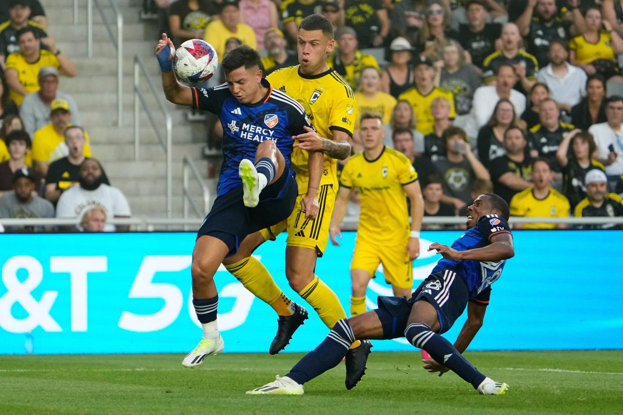 Aug 20, 2023; Columbus, Ohio, USA; FC Cincinnati midfielder Álvaro Barreal (31) commits a hand ball in front of Columbus Crew forward Christian Ramirez (17) leading to a penalty kick goal by forward Cucho Hernandez during the first half of the MLS soccer match at Lower.com Field.