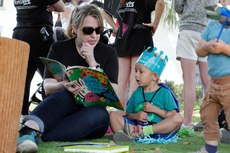 Early Learning Coalition of the Big Bend family services specialist Kristine Parker reads "Rumble in the Jungle" to August Weatherford, 3.