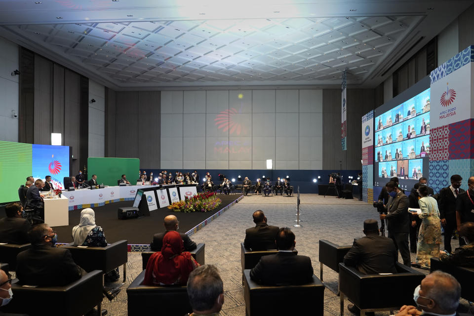 Malaysia's Prime Minister Muhyiddin Yassin, left center, attends the opening remarks of the first virtual Asia-Pacific Economic Cooperation (APEC) leaders' summit hosted by Malaysia in Kuala Lumpur, Malaysia, Friday, Nov. 20, 2020. (AP Photo/Vincent Thian)