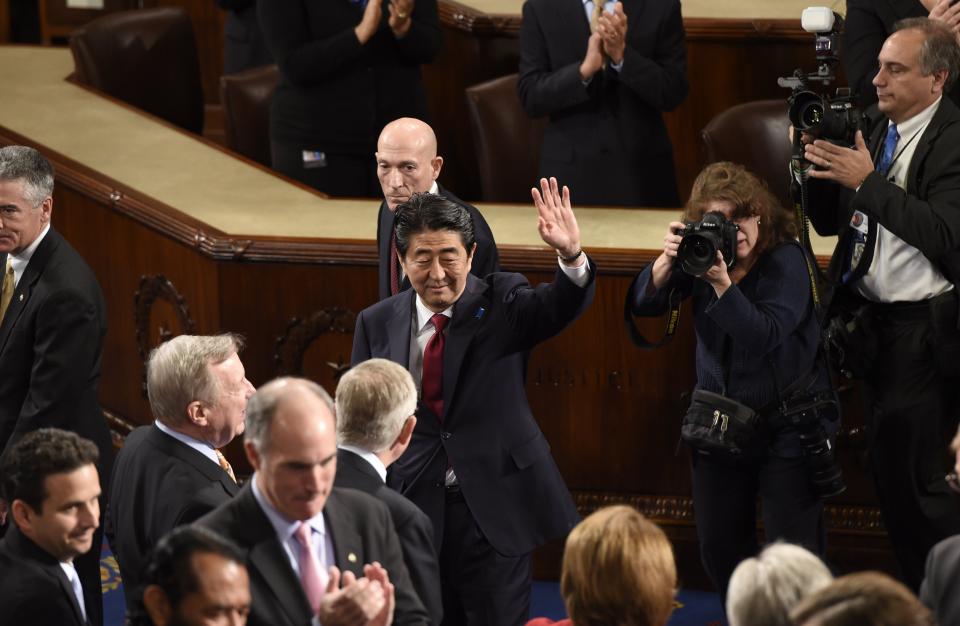 Japanese Prime Minister Shinzo Abe waves before he addresses a joint session of Congress at the U.S. Capitol in Washington, D.C., on April 29, 2015.