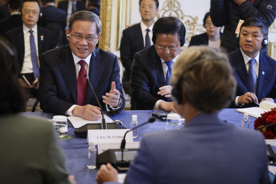 China's Prime Minister Li Qiang, left, attends a working session with French Prime Minister Elisabeth Borne Thursday, June 22, 2023 in Paris. World leaders, heads of international organizations and activists are gathering in Paris for a two-day summit aimed at seeking better responses to tackle poverty and climate change issues by reshaping the global financial system. (AP Photo/Thomas Padilla, Pool)