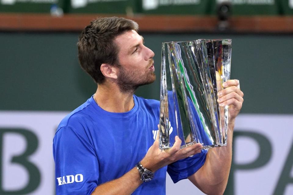 Britain’s Cameron Norrie kisses the trophy after defeating Nikoloz Basilashvili to take the BNP Paribas Open title (Mark J Terrill/AP) (AP)