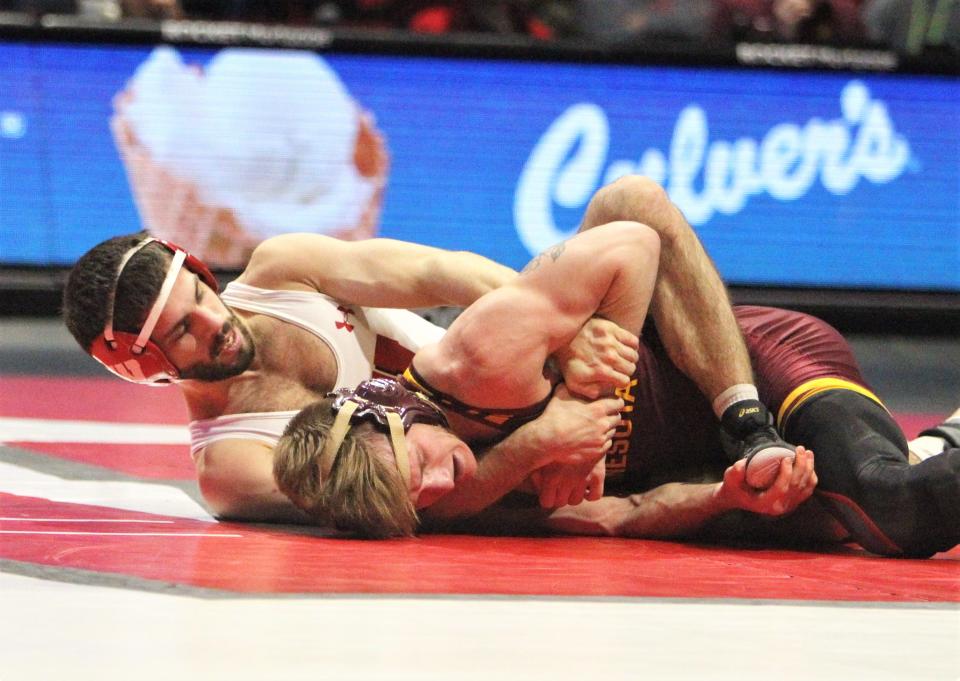 Wisconsin's Eric Barnett takes down Minnesota's Patrick Mckee during their 125-pound match of the teams' wrestling dual at the UW Field House in Madison on Feb 11. Barnett won the match, 5-4, but Minnesota won the dual, 19-15.