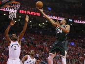 May 21, 2019; Toronto, Ontario, CAN; Milwaukee Bucks forward Giannis Antetokounmpo (34) shoots the ball as Toronto Raptors forward Kawhi Leonard (2) and Raptors guard Kyle Lowry (7) defend during game four of the Eastern conference finals of the 2019 NBA Playoffs at Scotiabank Arena. Mandatory Credit: John E. Sokolowski-USA TODAY Sports