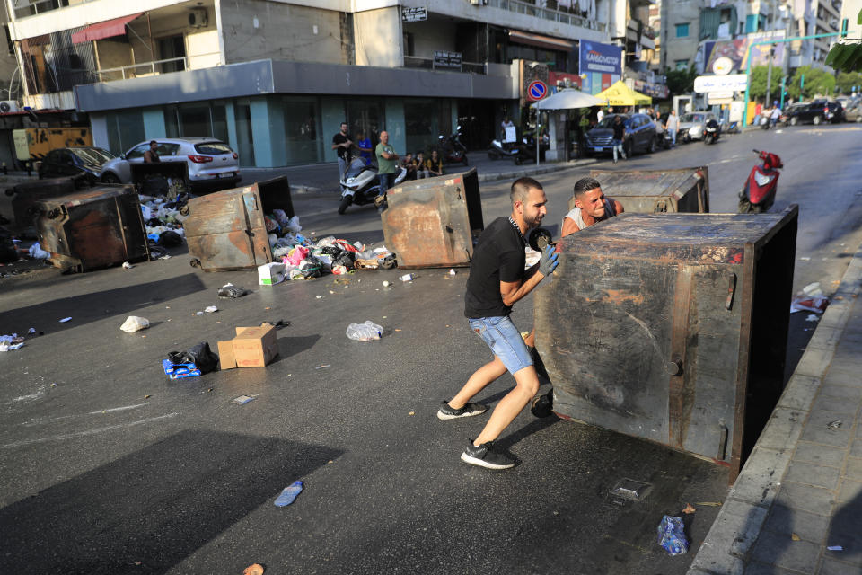 Saad Hariri's supporters block streets in Beirut, Lebanon, Thursday, July 15, 2021. Prime Minister-designate Saad Hariri says he is stepping down, nine months after he was named to the post by the parliament. He is citing "key differences" with the country's president, Michel Aoun. Thursday's announcement is likely to plunge the country further into more chaos and uncertainty. (AP Photo/Hussein Malla)