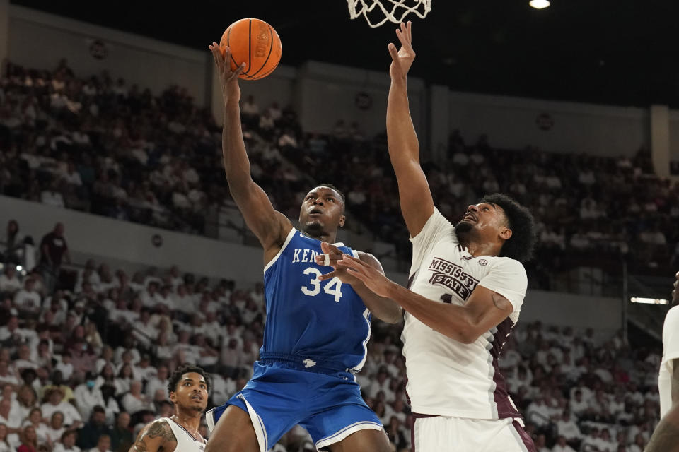 Kentucky forward Oscar Tshiebwe (34) attempts a layup while Mississippi State forward Tolu Smith (1) defends during the first half of an NCAA college basketball game in Starkville, Miss., Wednesday, Feb. 15, 2023. (AP Photo/Rogelio V. Solis)