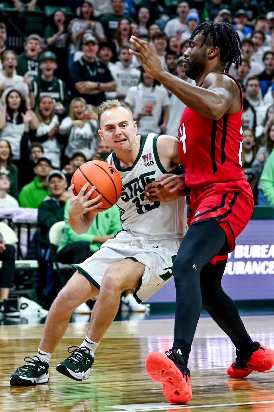 Michigan State's Steven Izzo, left, drives to the basket as Rutgers' Austin Williams defends during the second half on Sunday, Jan. 14, 2024, at the Breslin Center in East Lansing.