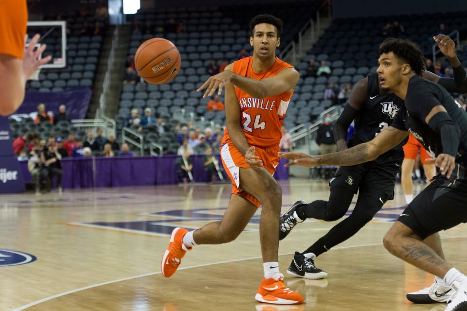 Evansville’s Preston Phillips (24) passes the ball as the University of Evansville Purple Aces play the University of Central Florida Knights at Ford Center Saturday afternoon, Nov. 20, 2021. 