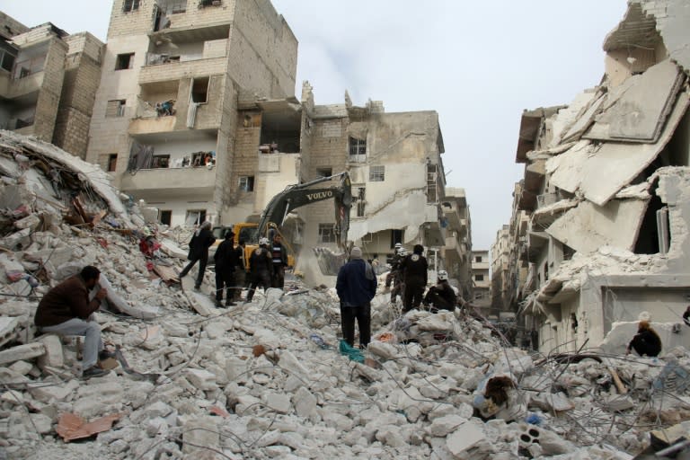 Syrian civil defence volunteers, known as the White Helmets, look for survivors amidst the debris following reported government airstrike on the Syrian town of Ariha, in the northwestern province of Idlib, on February 27, 2017