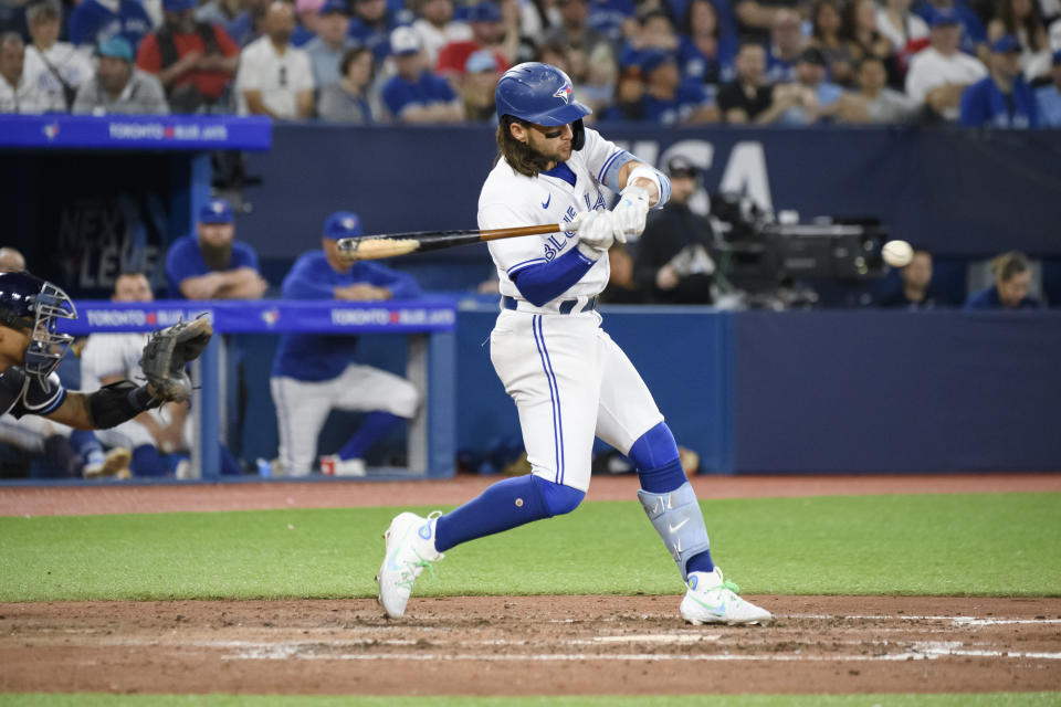 Toronto Blue Jays' Bo Bichette (11) doubles during the eighth inning of a baseball game against the Tampa Bay Rays in Toronto, Ontario, Friday, April 14, 2023. (Christopher Katsarov/The Canadian Press via AP)