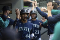 Seattle Mariners' Julio Rodriguez celebrates in the dugout after hitting a three-run home run off Oakland Athletics starting pitcher Matthew Festa during the third inning of a baseball game, Monday, May 23, 2022, in Seattle. The hit also scored Mariners' J.P. Crawford and Ty France. (AP Photo/Stephen Brashear)