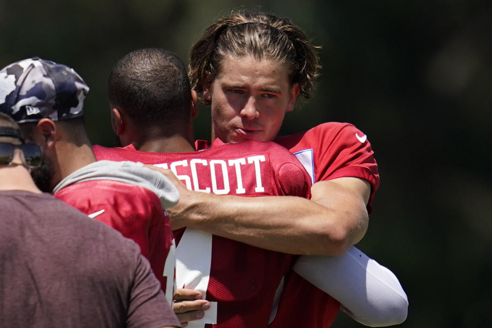 Los Angeles Chargers quarterback Justin Herbert, right, and Dallas Cowboys quarterback Dak Prescott (4) participate in drills during a combined NFL practice at the Los Angeles Rams' practice facility in Costa Mesa, Calif. Thursday, Aug. 18, 2022. (AP Photo/Ashley Landis)