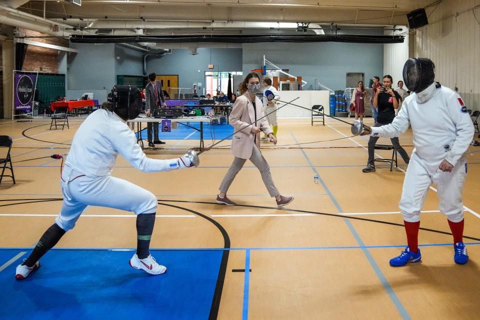 Daniel Musel, 18, of Clive, and Mat Johnstone, 36, of Des Moines, compete in an epee fencing tournament on August 28 in West Des Moines. The tournament was co-hosted by the Des Moines Fencing Club and Red Door Fencing.