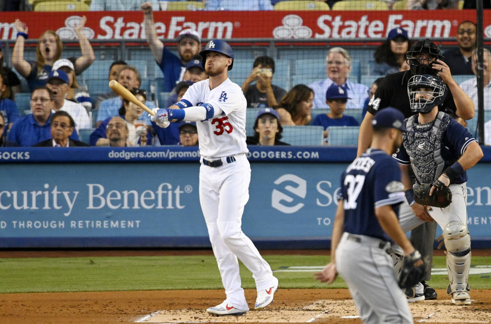 Los Angeles Dodgers' Cody Bellinger, left, heads to first on a solo home run off San Diego Padres' Joey Lucchesi, who walks off the mound, while catcher Austin Hedges and home plate umpire John Libka watch during the second inning of a baseball game Thursday, Aug. 1, 2019, in Los Angeles. (AP Photo/Mark J. Terrill)