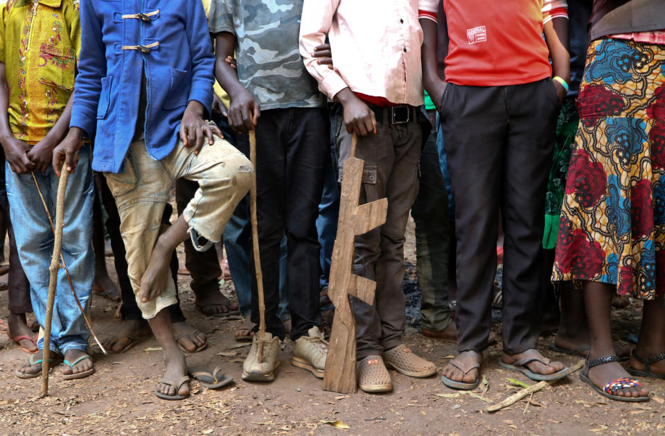 FILE - In this Wednesday, Feb. 7, 2018 file photo, former child soldiers stand in line waiting to be registered with UNICEF to receive a release package, in Yambio, South Sudan. A new report made public in Nov. 2019 says South Sudan's National Security Service has recruited a force of 10,000 fighters in President Salva Kiir's ethnic stronghold, in apparent breach of the terms of the country's peace deal. (AP Photo/Sam Mednick, File)