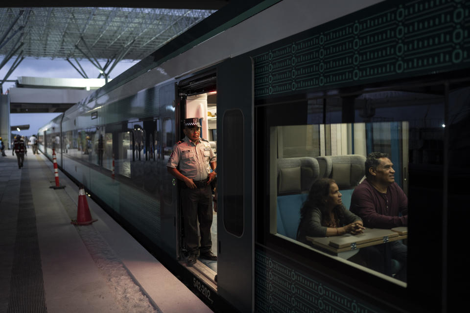 A Mayan Train worker waits for passengers to board in Cancun, Mexico, Wednesday, March 6, 2024. When it's completed, the high-speed Maya Train will wind around Mexico's southern Yucatan peninsula. (AP Photo/Rodrigo Abd)