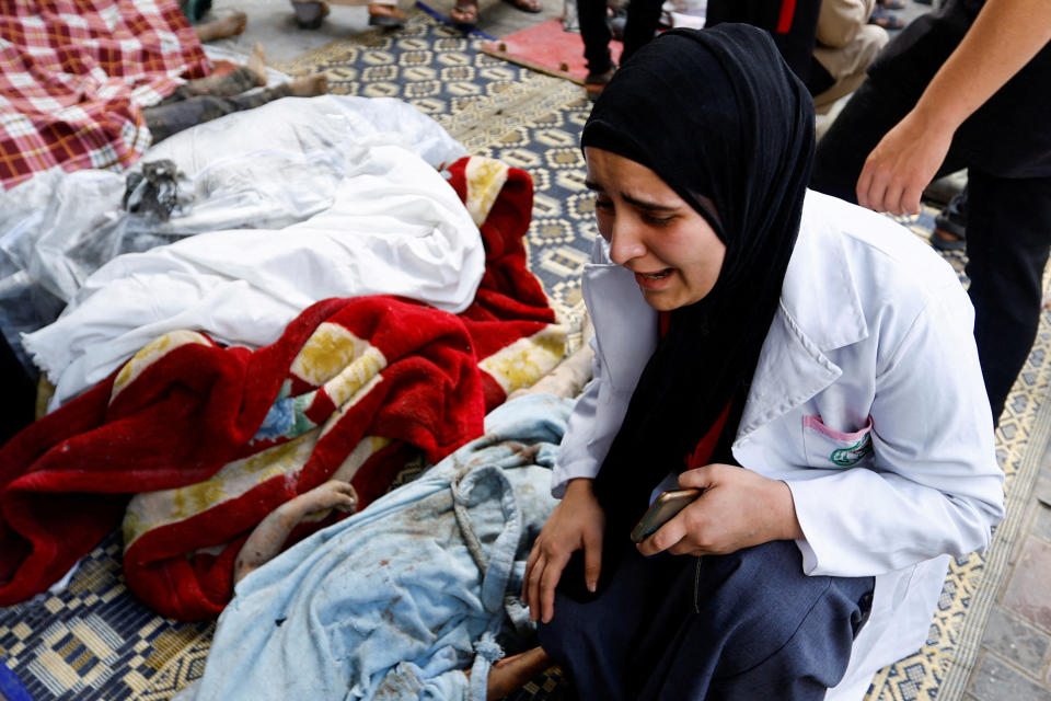 A woman at a hospital in the southern Gaza Strip on Tuesday with bodies of Palestinians killed in Israeli strikes.