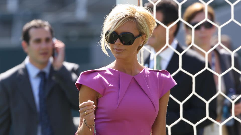 By 2007, Victoria had welcomed in one of her most distinctive haircuts — the blonde 'pob' (Posh bob). Here in California to support David as the new member of the LA Galaxy soccer team, the cropped cut was off-set with a Barbie pink ensemble, featuring one of Victoria's many Birkin bags. - Robyn Beck/AFP/Getty Images
