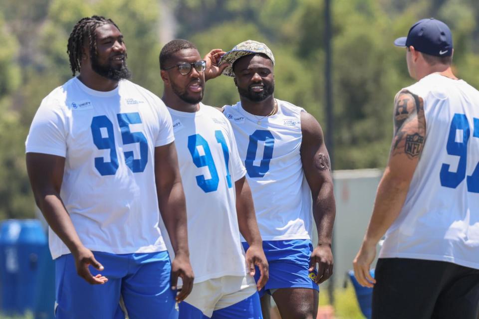 Rams Byron Young (0), Bobby Brown III (95), Kobie Turner (91) and Michael Hoecht (97) assemble during an OTA practice.