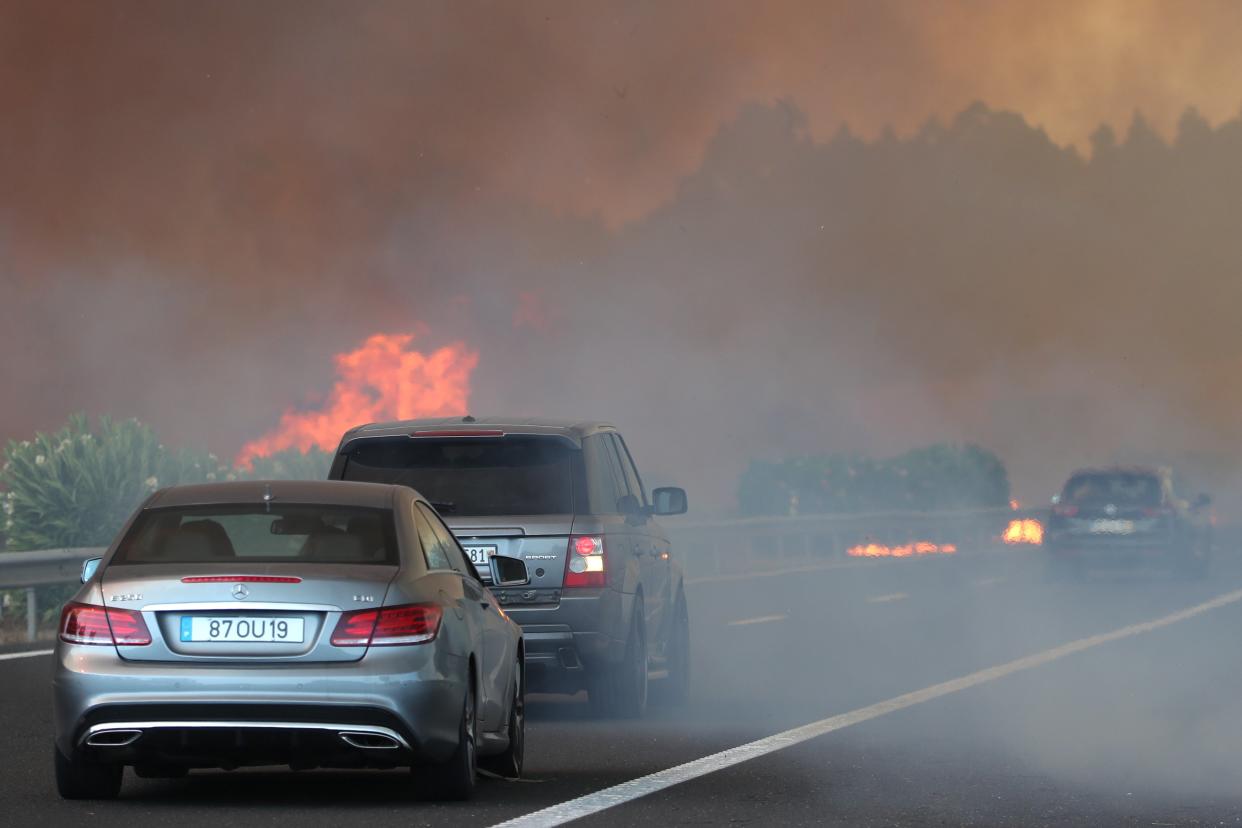 Smoke billows in the sky near the A1 highway in the locality of Cardosos (EPA)