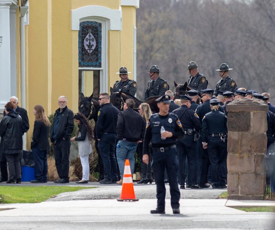 From Jefferson Street, near Pond Street, people and law enforcement officers wait in line during the viewing of Pennsylvania State Trooper Martin Mack III, held at the Wade Funeral Home in Bristol Borough, on Wednesday, March 30, 2022