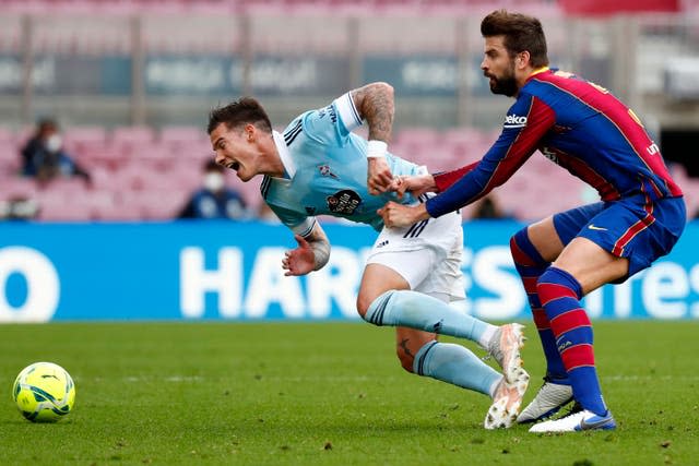 Celta Vigo’s Santi Mina fights for the ball against Barcelona’s Gerard Pique