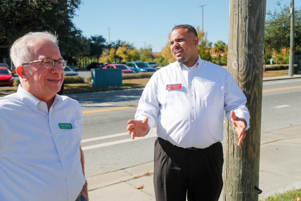 Derek Mallow, candidate for Georgia State Senate, right0 talks with U.S. House of Representatives candidate Wade Herring on Tuesday November 8, 2022 while in line at Randy's Bar B Q in Savannah.