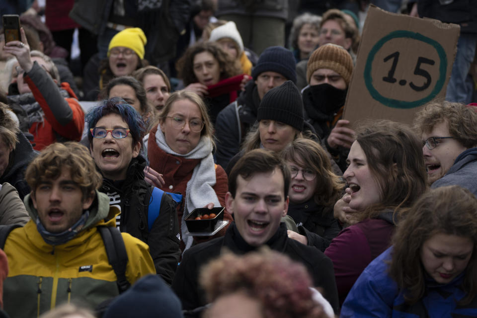 FILE - Extinction Rebellion activists and sympathizers shouted slogans against global warming when blocking a busy road in The Hague, Netherlands, Jan. 28, 2023. There’s a two-out-of-three chance within the next five years that the world will temporarily reach the internationally accepted global temperature threshold for limiting the worst effects of climate change, a new World Meteorological Organization report forecasts on Wednesday, May 17, 2023. (AP Photo/Peter Dejong, File)