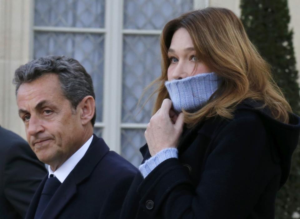 Former French President Nicolas Sarkozy and his wife Carla Bruni-Sarkozy arrive at the Elysee Palace before attending a solidarity march in the streets of Paris